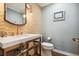 Stylish powder room featuring a modern vanity, striking stone accent wall, and elegant fixtures at 5340 S Logan Dr, Greenwood Village, CO 80121