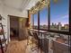 Cozy balcony seating with beautiful city views through large windows with decorative string lights at 800 N Pearl St # 709, Denver, CO 80203