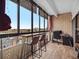 Urban balcony with floor-to-ceiling windows offering panoramic views, seating, and a dedicated workspace at 800 N Pearl St # 709, Denver, CO 80203