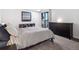 Neutral bedroom boasts a modern dresser and minimalist decor with balcony access at 800 N Pearl St # 709, Denver, CO 80203