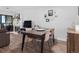 Open dining area featuring sleek wood floors, a modern table with seating for four, and a cozy fireplace at 800 N Pearl St # 709, Denver, CO 80203