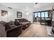 Inviting living room with comfortable seating, a cozy fireplace, and access to the balcony at 800 N Pearl St # 709, Denver, CO 80203