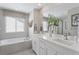 Bright bathroom with double vanity, soaking tub, and contemporary finishes at 13334 Blue Amber Ct, Parker, CO 80134