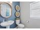 Chic powder room featuring a pedestal sink, modern fixtures, and stylish decor at 13334 Blue Amber Ct, Parker, CO 80134