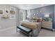 Comfortable bedroom with aviation themed decor, featuring a cozy bed, bench, and ample natural light at 13334 Blue Amber Ct, Parker, CO 80134