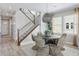Dining area with round table, unique light fixture, and staircase view at 13334 Blue Amber Ct, Parker, CO 80134