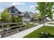 Charming two-story home featuring gray siding, a well-manicured lawn, and a quaint wooden fence at 13334 Blue Amber Ct, Parker, CO 80134