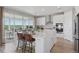 Open kitchen featuring a spacious island, seating, modern appliances, and scenic views at 13334 Blue Amber Ct, Parker, CO 80134