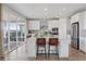 Modern kitchen island with seating, stainless steel appliances, and sliding door access to balcony at 13334 Blue Amber Ct, Parker, CO 80134