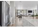 Open concept kitchen with stainless appliances, view into dining and living spaces at 13334 Blue Amber Ct, Parker, CO 80134