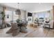 Open-concept living room featuring a fireplace, large windows, and stylish decor at 13334 Blue Amber Ct, Parker, CO 80134