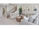 Cozy living room with modern decor, featuring comfortable seating, a unique coffee table, and staircase at 13334 Blue Amber Ct, Parker, CO 80134