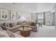 Bright living room featuring a large sectional sofa, round wood coffee table, and decorative wall art at 13334 Blue Amber Ct, Parker, CO 80134