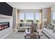 Bright living room featuring a fireplace, comfortable couches, and a scenic view at 13334 Blue Amber Ct, Parker, CO 80134