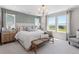 Bright primary bedroom with a king bed, bench, large windows, and natural light at 13334 Blue Amber Ct, Parker, CO 80134