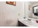 Well-lit bathroom with vanity sink, mirror, and decorative accents creating a serene atmosphere at 14486 E Hawaii Cir # D, Aurora, CO 80012
