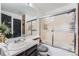 Bathroom featuring a vanity sink, toilet, and a sliding glass door shower at 14486 E Hawaii Cir # D, Aurora, CO 80012