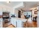 Bright kitchen with white cabinetry, modern appliances, and a breakfast bar for casual dining at 14486 E Hawaii Cir # D, Aurora, CO 80012