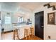 Efficient kitchen with white cabinets, breakfast bar, and easy access to the dining and living areas at 14486 E Hawaii Cir # D, Aurora, CO 80012