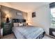Comfortable bedroom featuring a dark bed frame, a dresser, and warm lighting for a relaxing ambiance at 14486 E Hawaii Cir # D, Aurora, CO 80012