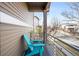 A cozy balcony with a blue Adirondack chair, offering views of the neighborhood street at 18143 E 104Th Way, Commerce City, CO 80022