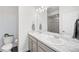 Bright bathroom with a double sink vanity, modern lighting, and a glass shower enclosure at 18143 E 104Th Way, Commerce City, CO 80022