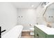 Stylish bathroom featuring a freestanding tub, updated vanity, and modern decor at 18143 E 104Th Way, Commerce City, CO 80022
