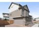 Three-story home with vinyl siding, brick foundation, an attached two-car garage, and a well-manicured lawn at 18143 E 104Th Way, Commerce City, CO 80022