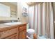 Traditional bathroom with wood vanity, neutral walls, sink, and shower with curtain at 1795 Mountain Creek Dr, Georgetown, CO 80444