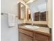 A traditional bathroom vanity features a stone countertop, wooden cabinets, and mounted mirrors at 1795 Mountain Creek Dr, Georgetown, CO 80444