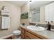 Bathroom with wood vanity, neutral paint, and a mountain landscape art piece at 1795 Mountain Creek Dr, Georgetown, CO 80444