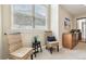 Bright bedroom area features neutral walls, two wicker chairs, and a window view at 1795 Mountain Creek Dr, Georgetown, CO 80444