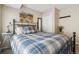 Comfortable bedroom features metal bed frame, carpeting, neutral walls, and mountain-themed artwork at 1795 Mountain Creek Dr, Georgetown, CO 80444