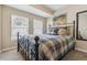 Bedroom with neutral walls, carpet, two windows, metal bed frame and mountain-themed artwork at 1795 Mountain Creek Dr, Georgetown, CO 80444