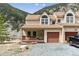 Inviting two-story townhouse with a covered porch, garage, and scenic mountain backdrop at 1795 Mountain Creek Dr, Georgetown, CO 80444