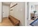 Hallway featuring a wood bench, coat hooks, and wood flooring with neutral paint colors at 1795 Mountain Creek Dr, Georgetown, CO 80444