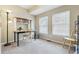 Cozy home office with two large windows, desk, shelving, and carpeting at 1795 Mountain Creek Dr, Georgetown, CO 80444
