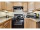 Efficient kitchen featuring black appliances and oak cabinetry, offering practical cooking space at 1795 Mountain Creek Dr, Georgetown, CO 80444