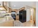 Functional kitchen with oak cabinets, laminate countertops, black appliances, and light wood flooring at 1795 Mountain Creek Dr, Georgetown, CO 80444