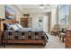 Main bedroom featuring high ceilings, a comfortable bed, and mountain view artwork at 1795 Mountain Creek Dr, Georgetown, CO 80444