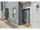 Modern townhouse featuring a stylish front door, sleek siding, and a welcoming entryway at 1810 Irving St # 4, Denver, CO 80204
