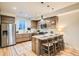Well-lit kitchen boasts wooden cabinetry, a stainless-steel refrigerator, and a functional center island at 1810 Irving St # 4, Denver, CO 80204