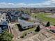 This aerial perspective highlights the home with gardens, landscaping, modern neighborhood development, and a community park at 7890 W 43Rd Pl, Wheat Ridge, CO 80033