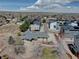 Drone-eye-view of this house and its yard nestled next to modern townhomes with solar panels and community garden plots at 7890 W 43Rd Pl, Wheat Ridge, CO 80033