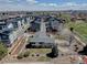 The aerial view captures a home near new townhouses, plus maintained landscaping and gardens in a vibrant community at 7890 W 43Rd Pl, Wheat Ridge, CO 80033