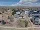 This image showcases the home surrounded by landscaping, community gardens, and nearby modern townhome construction at 7890 W 43Rd Pl, Wheat Ridge, CO 80033