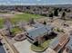 Expansive aerial view showcasing the home, lush landscaping, and proximity to community park and garden plots at 7890 W 43Rd Pl, Wheat Ridge, CO 80033