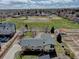 Aerial photo presenting the home adjacent to a community park, garden plots, and modern neighborhood developments at 7890 W 43Rd Pl, Wheat Ridge, CO 80033