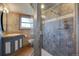 Bathroom featuring a glass shower, modern vanity, and neutral wall and floor tiles at 7890 W 43Rd Pl, Wheat Ridge, CO 80033