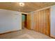 Simple room with closet doors, neutral walls, and wood paneled ceiling at 7890 W 43Rd Pl, Wheat Ridge, CO 80033